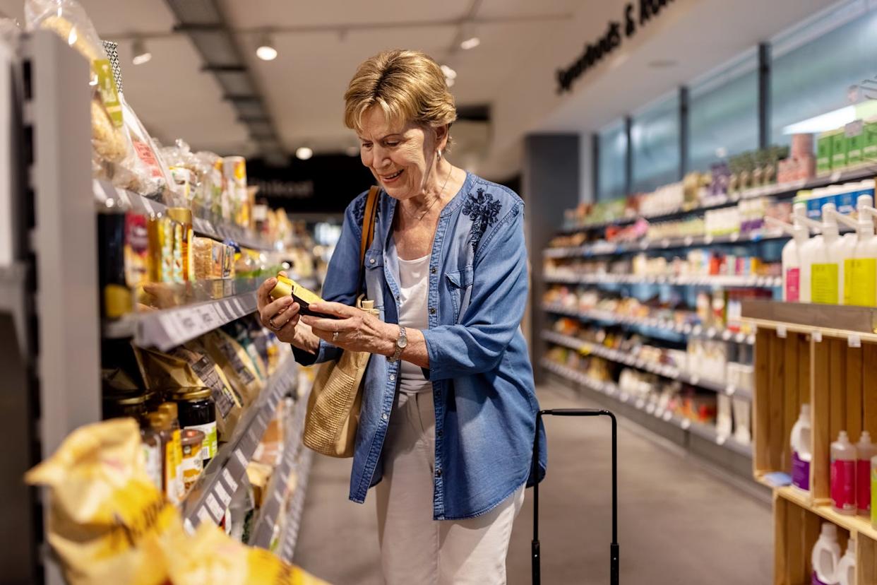Elderly woman buying grocery products in supermarket