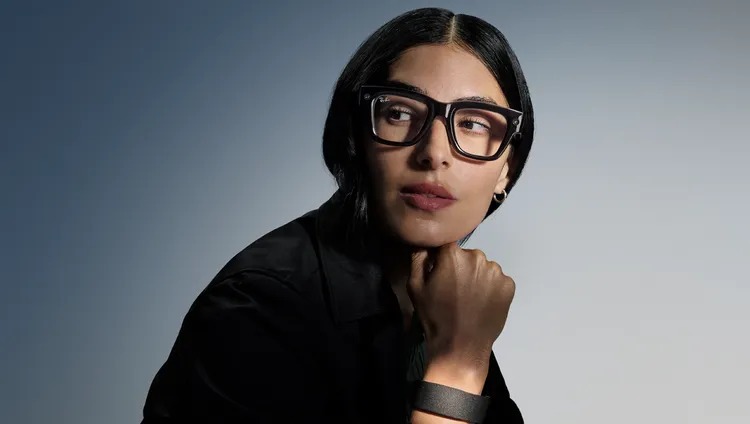 A woman wearing Ray-Ban Meta smart glasses.