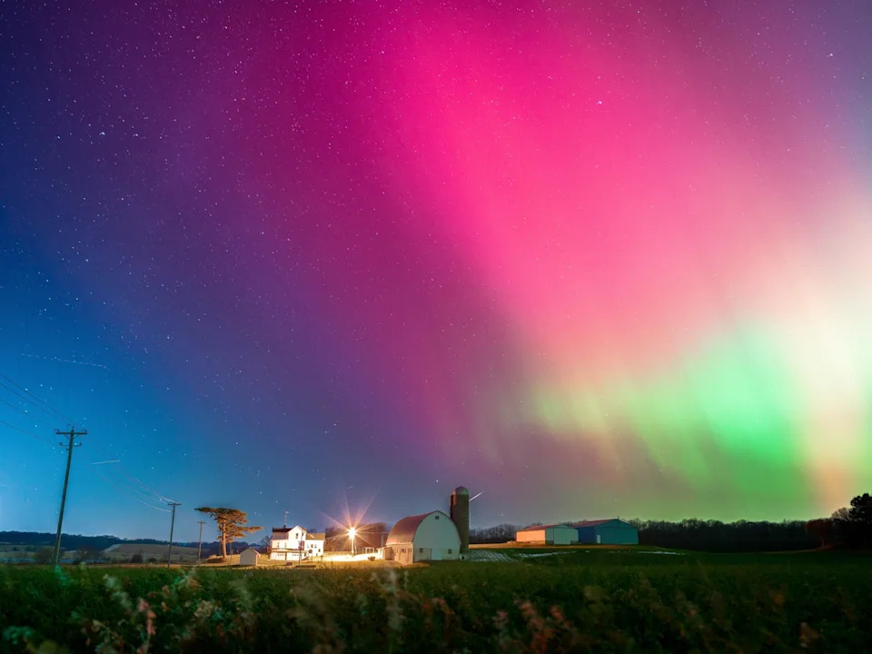 Ross Harried/NurPhoto via Getty Images - PHOTO: The Aurora Borealis lights up the night sky over Monroe, Wisconsin, on November 11, 2025.