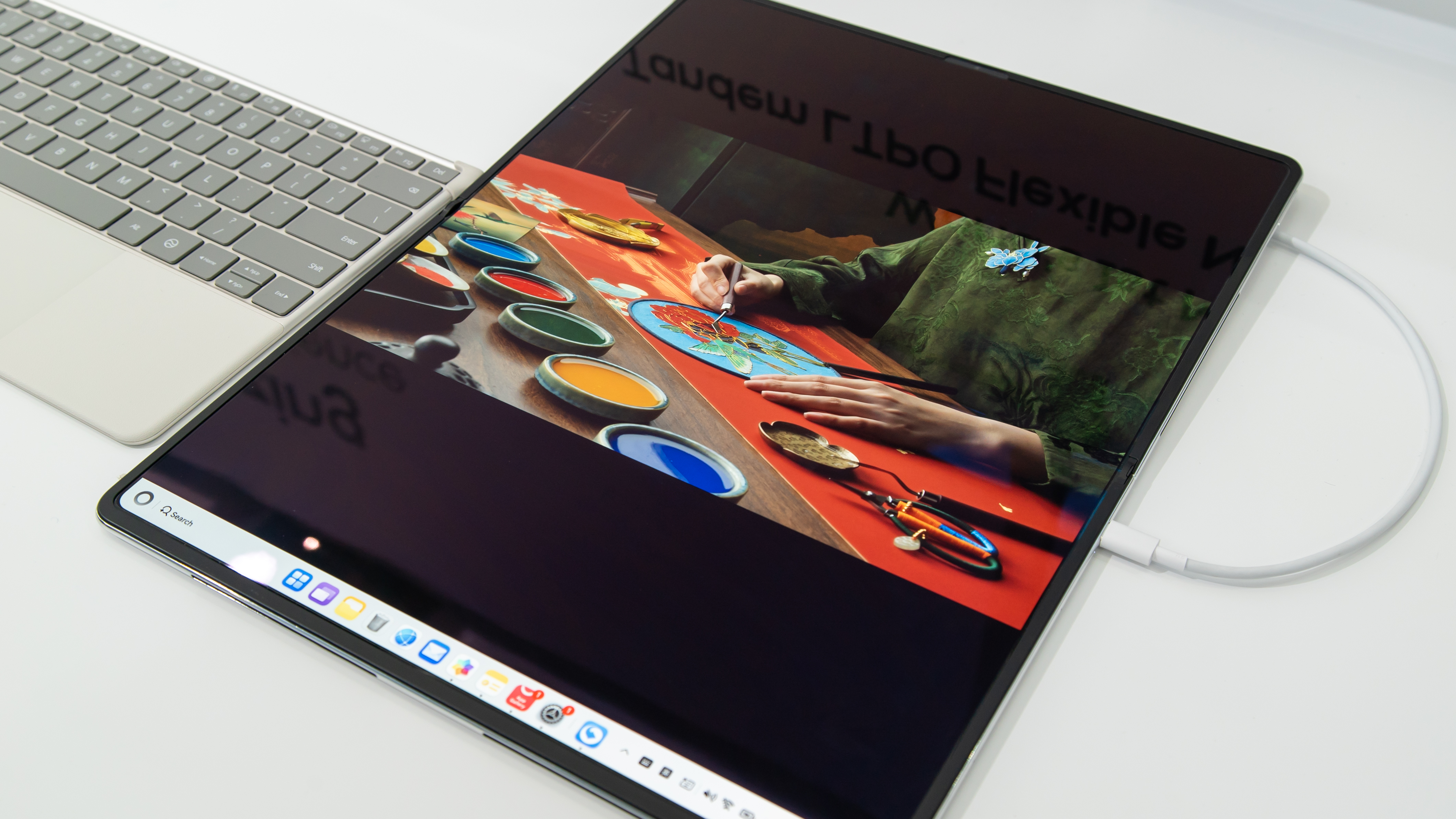 A foldable laptop lying flat on a surface