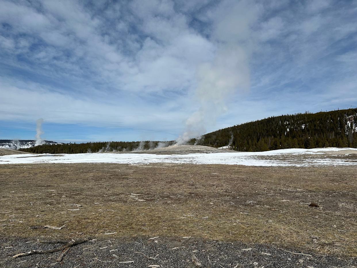 Steam rises out of Old Faithful between eruptions.