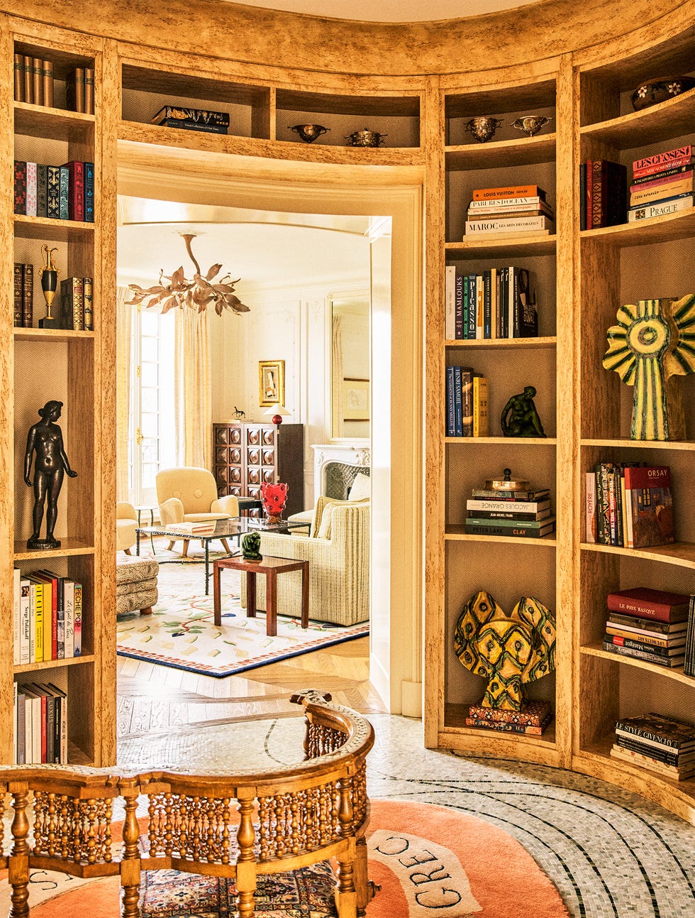 A stylish interior featuring a bookshelf and view into another room.
