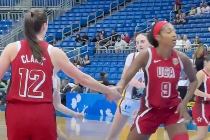 Caitlin Clark and Angel Reese high five under the basket
