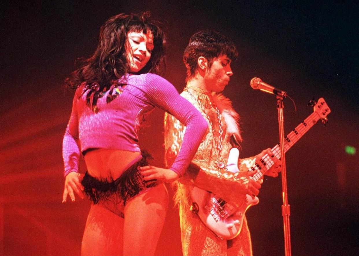 Prince with Mayte Garcia onstage. - 