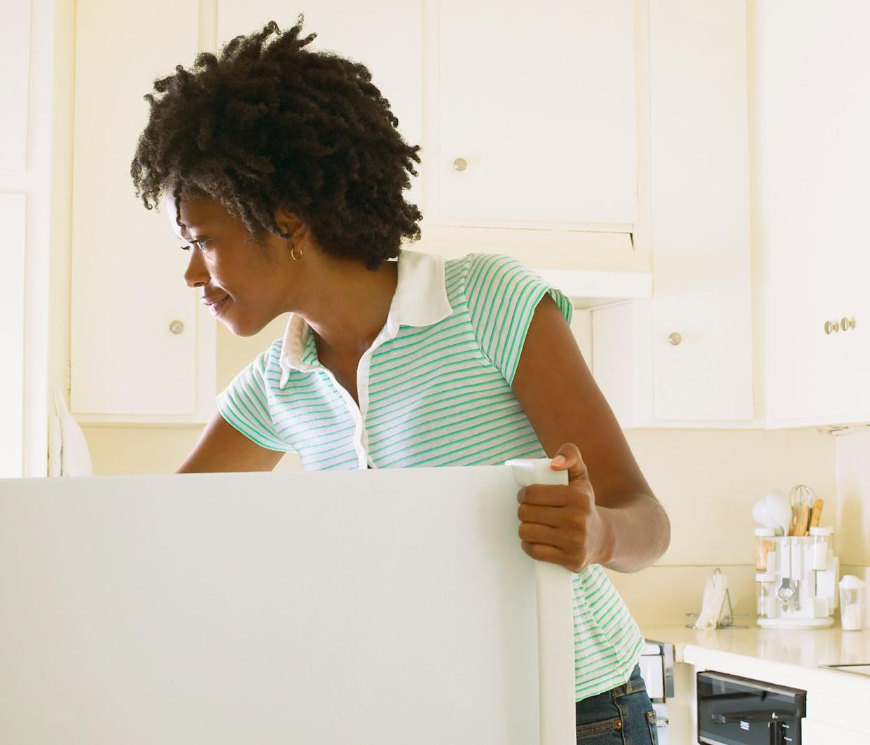 Woman Reaching into Refrigerator