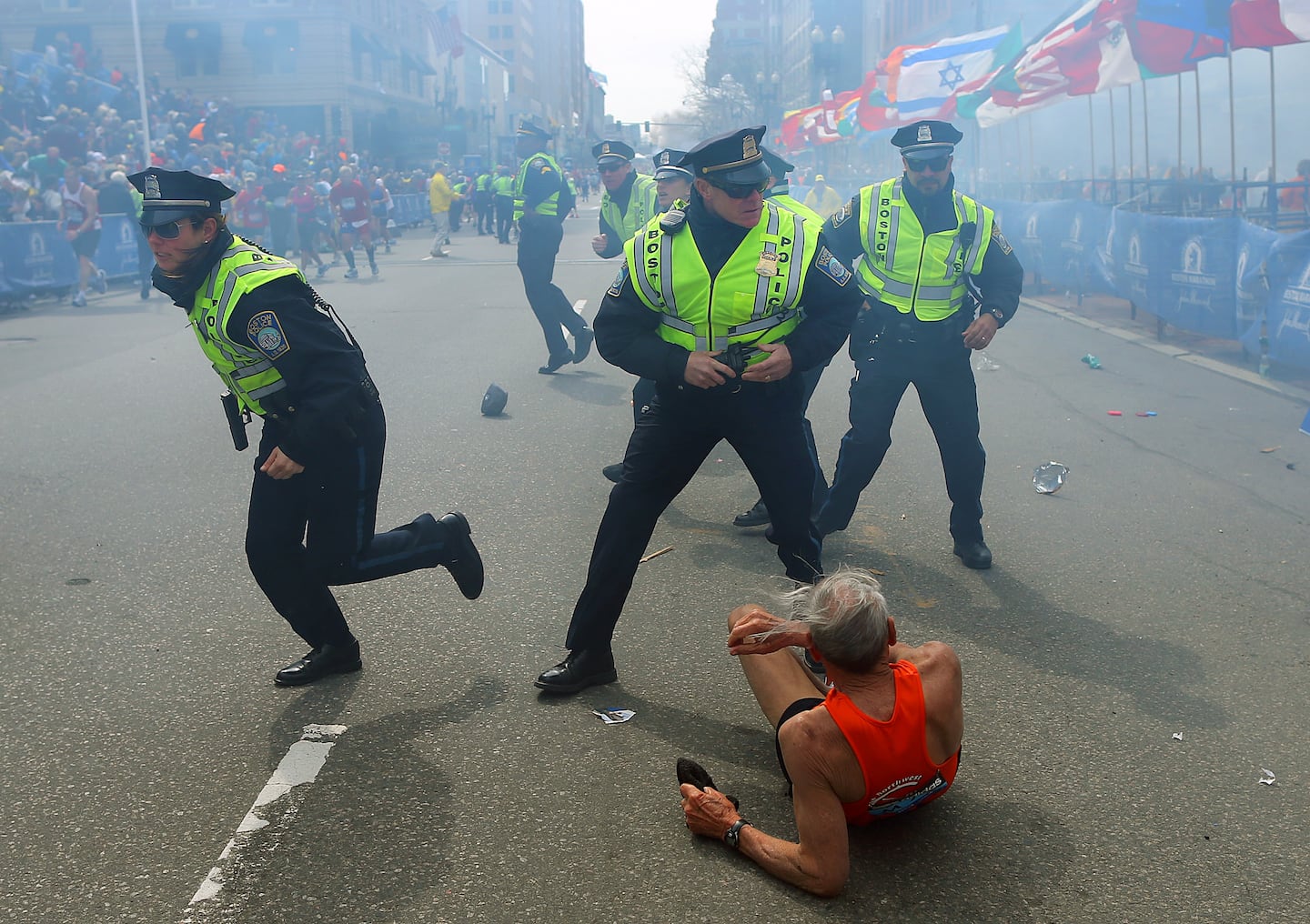 On the day of the Marathon bombings, police officers with their guns drawn reacted to the second explosion down the street. The first explosion knocked down a runner Bill Iffrig, 78, at the finish line of the Boston Marathon, on Apr. 15, 2013.