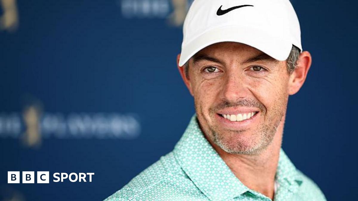 Rory McIlroy wearing a baseball cap and smiling