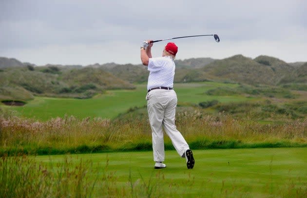 Donald Trump strikes the first ball at his Trump International Golf Links course in Aberdeen, Scotland, as it opens on July 10, 2012.