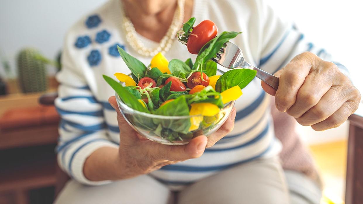 Older woman eating salad
