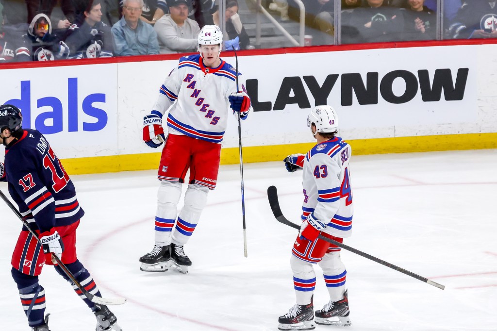 Adam Edstrom #84 of the New York Rangers celebrates a third period goal against the Winnipeg Jets with Conor Sheary #43.