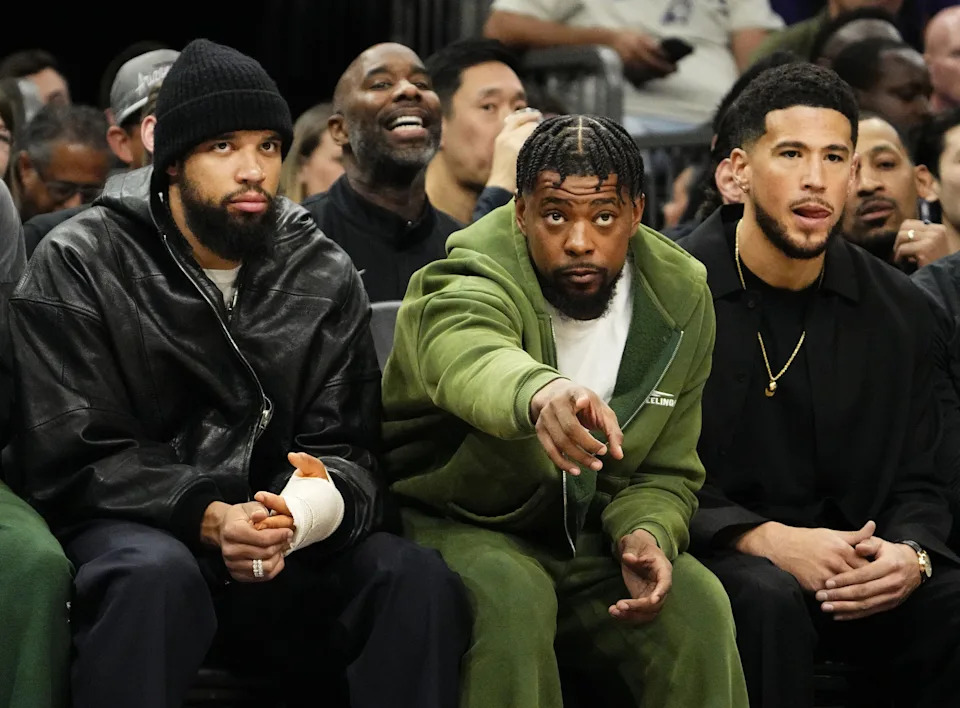 Phoenix Suns' Dillon Brooks, Jordan Goodwin, and Devin Booker (right) watch the action against the Los Angeles Lakers at Mortgage Matchup Center on Feb. 26, 2026, in Phoenix.