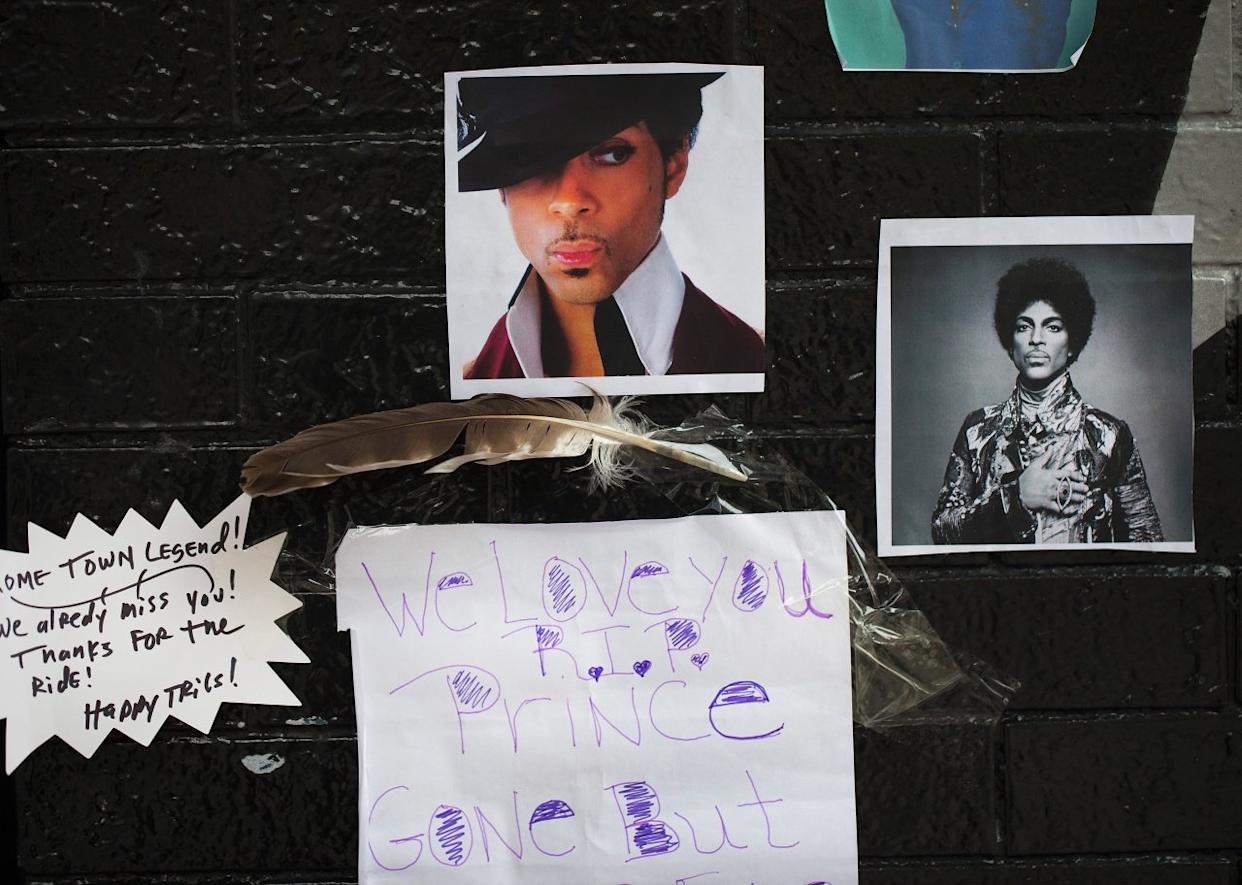 Photos of Prince on the wall outside of the First Avenue nightclub where fans created a memorial. - 