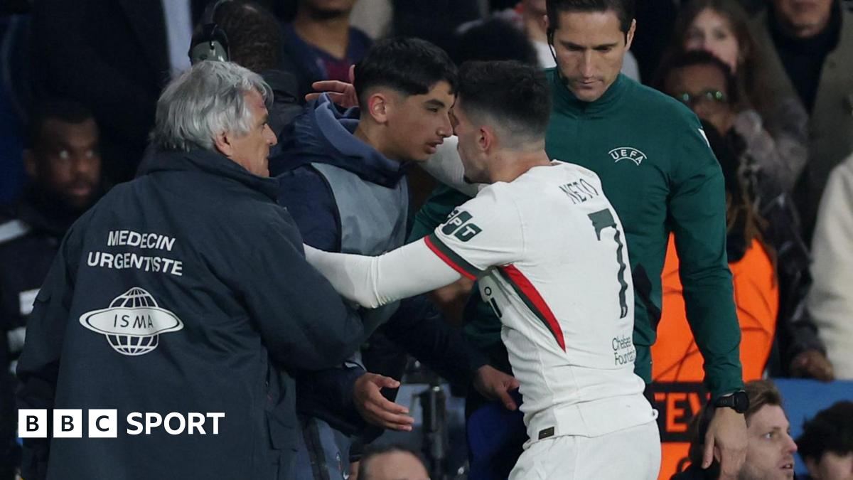 Chelsea's Pedro Neto embraces a PSG ball boy in the aftermath of shoving him during their Champions League match