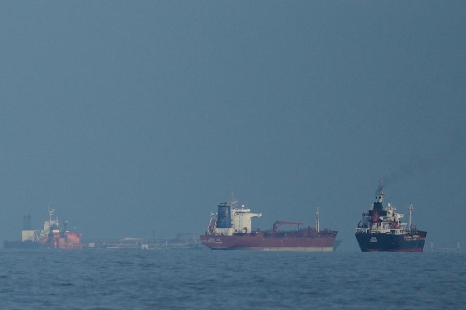 Oil tankers and cargo ships line up in the Strait of Hormuz as seen from Khor Fakkan, United Arab Emirates, Wednesday, March 11, 2026. (AP Photo/Altaf Qadri)