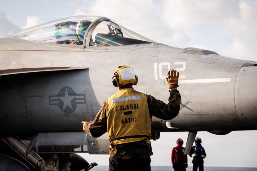 A US sailor signals to an F/A-18E Super Hornet aircraft, attached to Strike Fighter Squadron 37, on the flight deck of the world’s largest aircraft carrier, USS Gerald R. Ford, while operating in support of Operation Epic Fury in the Eastern Mediterranean Sea, on Monday, March 2.