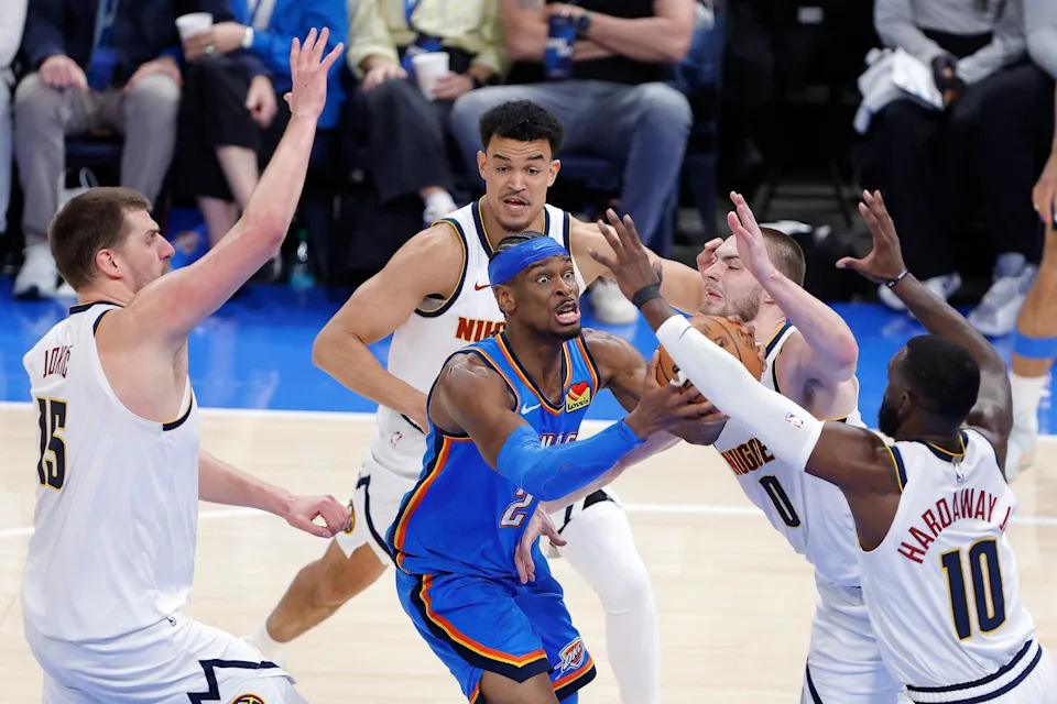 Mar 9, 2026; Oklahoma City, Oklahoma, USA; Oklahoma City Thunder guard Shai Gilgeous-Alexander (2) drives between Denver Nuggets defenders during the second half at Paycom Center. Mandatory Credit: Alonzo Adams-Imagn Images
