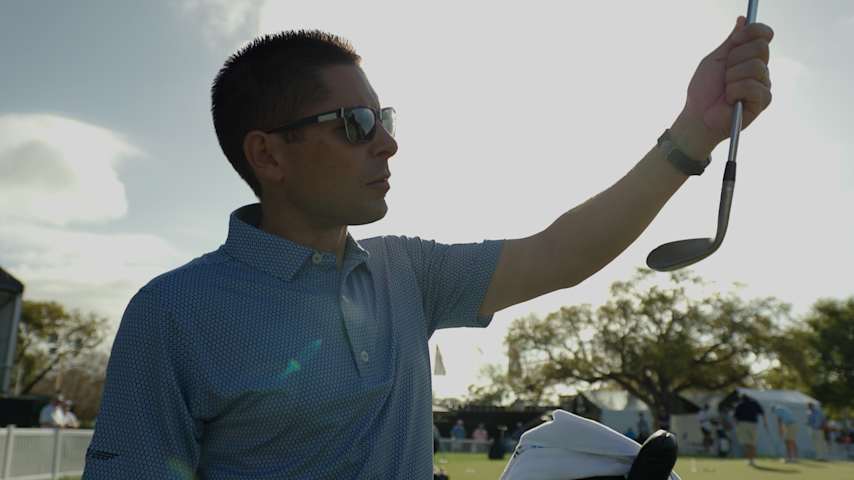 Aaron Dill, Vokey Wedge Tour Director, inspects a wedge at the Arnold Palmer Invitational. (PGA TOUR)