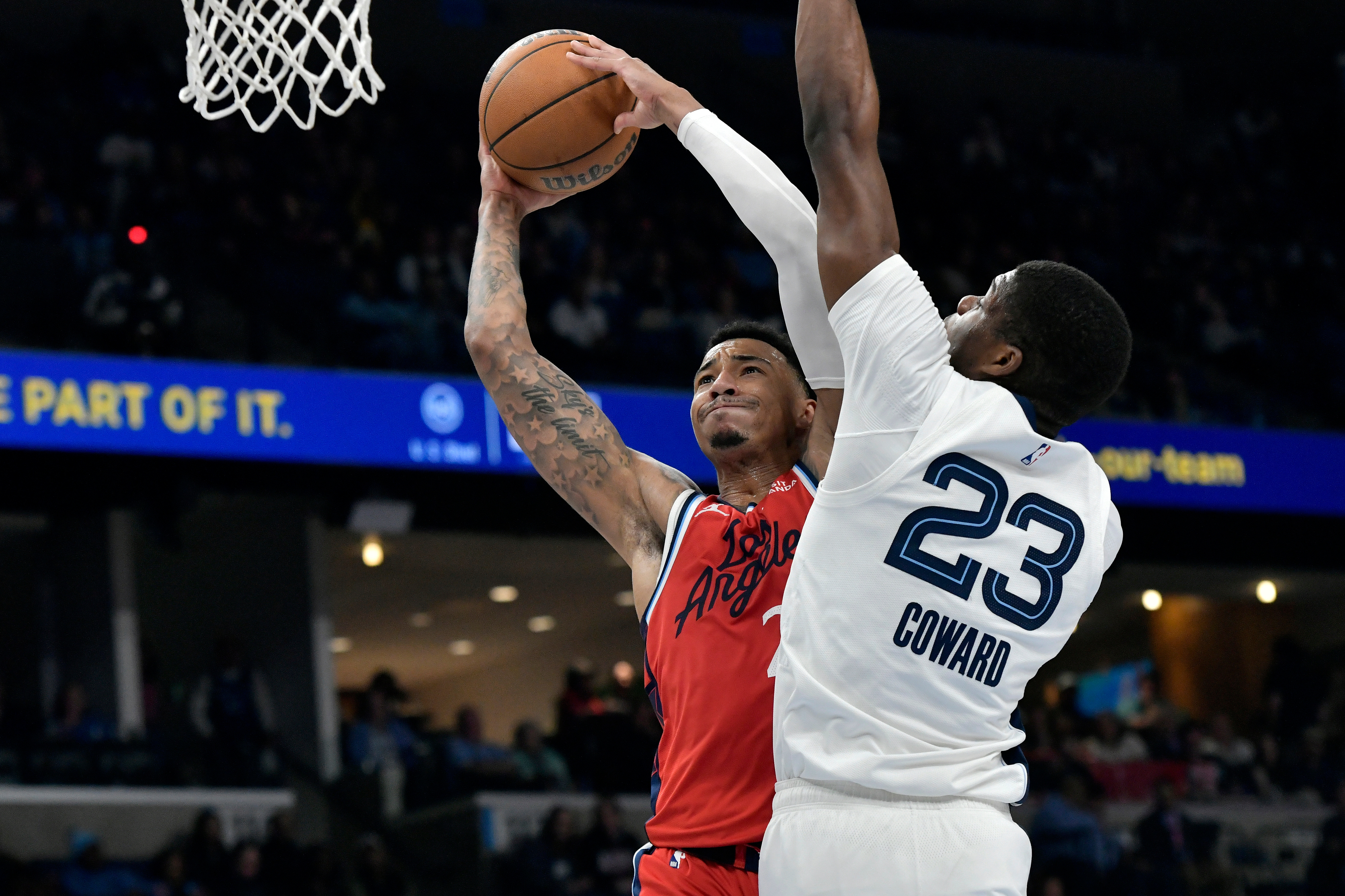 Clippers guard Jordan Miller, left, shoots against Memphis Grizzlies forward...