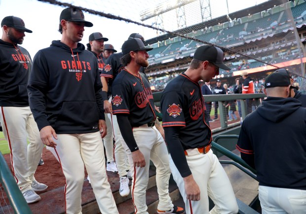 San Francisco Giants players enter the dugout before their MLB game against the Sultanes de Monterrey at Oracle Park in San Francisco, Calif., on Monday, March 23, 2026. (Jane Tyska/Bay Area News Group)