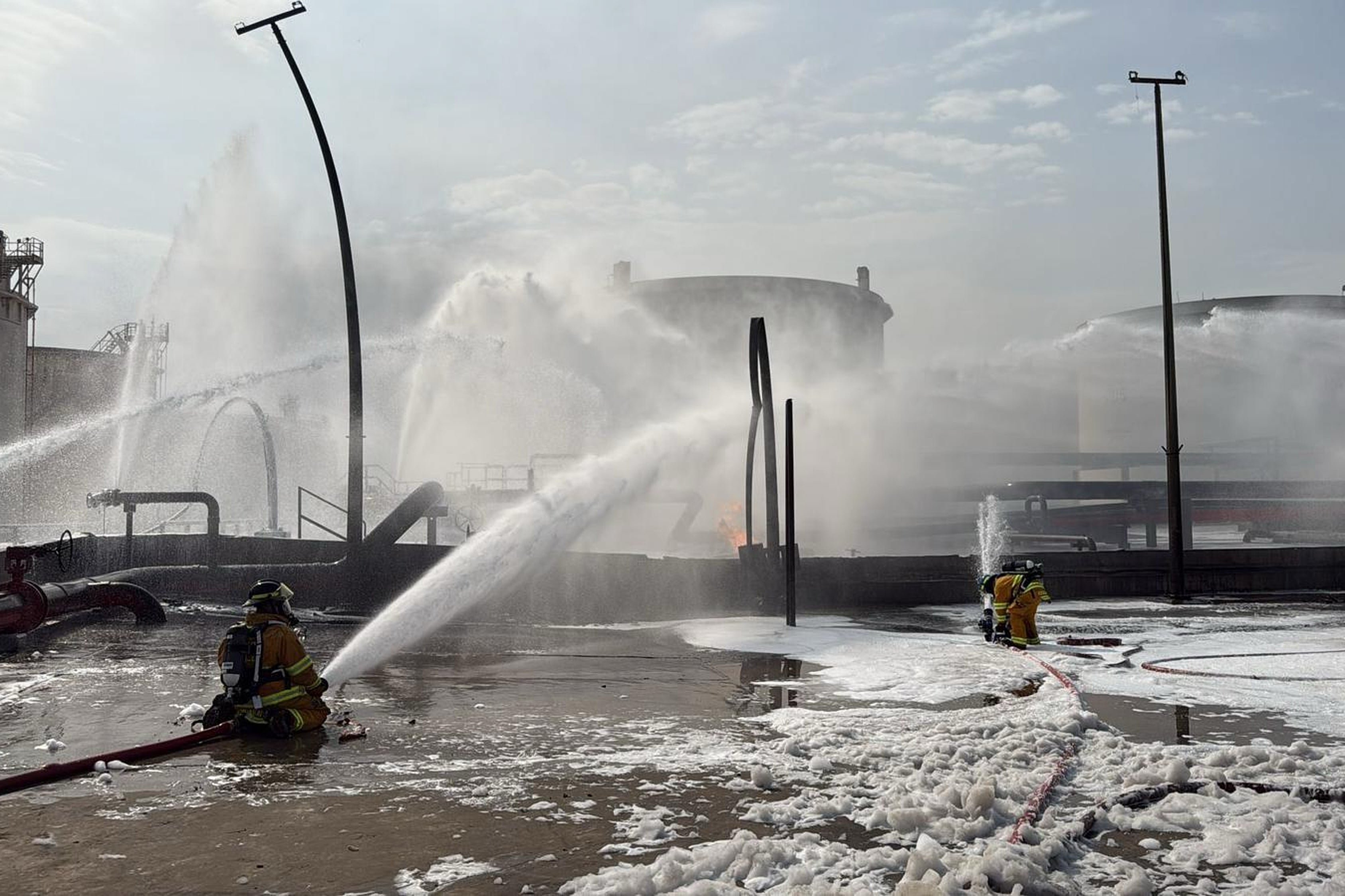 This image released by Bahrain's Interior Ministry shows firefighters extinguishing flames after an Iranian projectile struck an industrial area in Ma'ameer, Bahrain, Monday, March 9