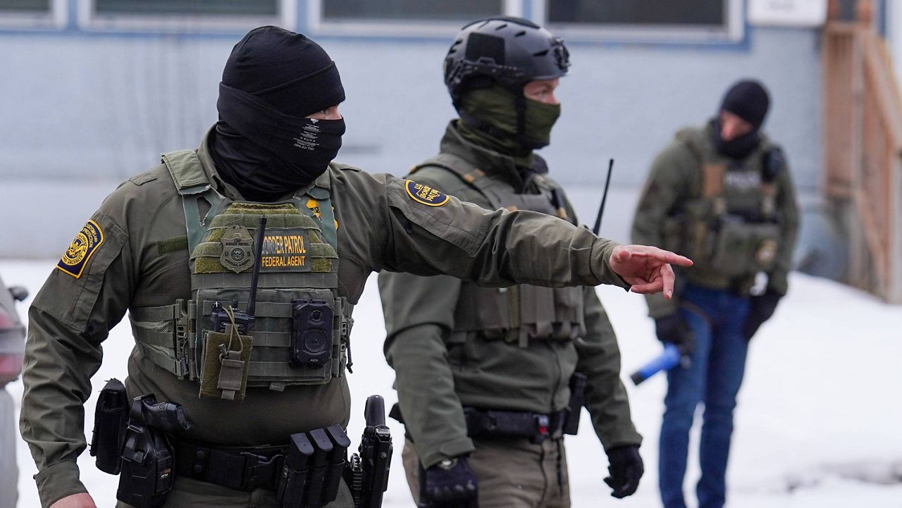 A United States Border Patrol agent gestures to a car while conducting immigration enforcement operations, Thursday, Feb. 5, 2026, in Minneapolis. (AP Photo/Ryan Murphy)