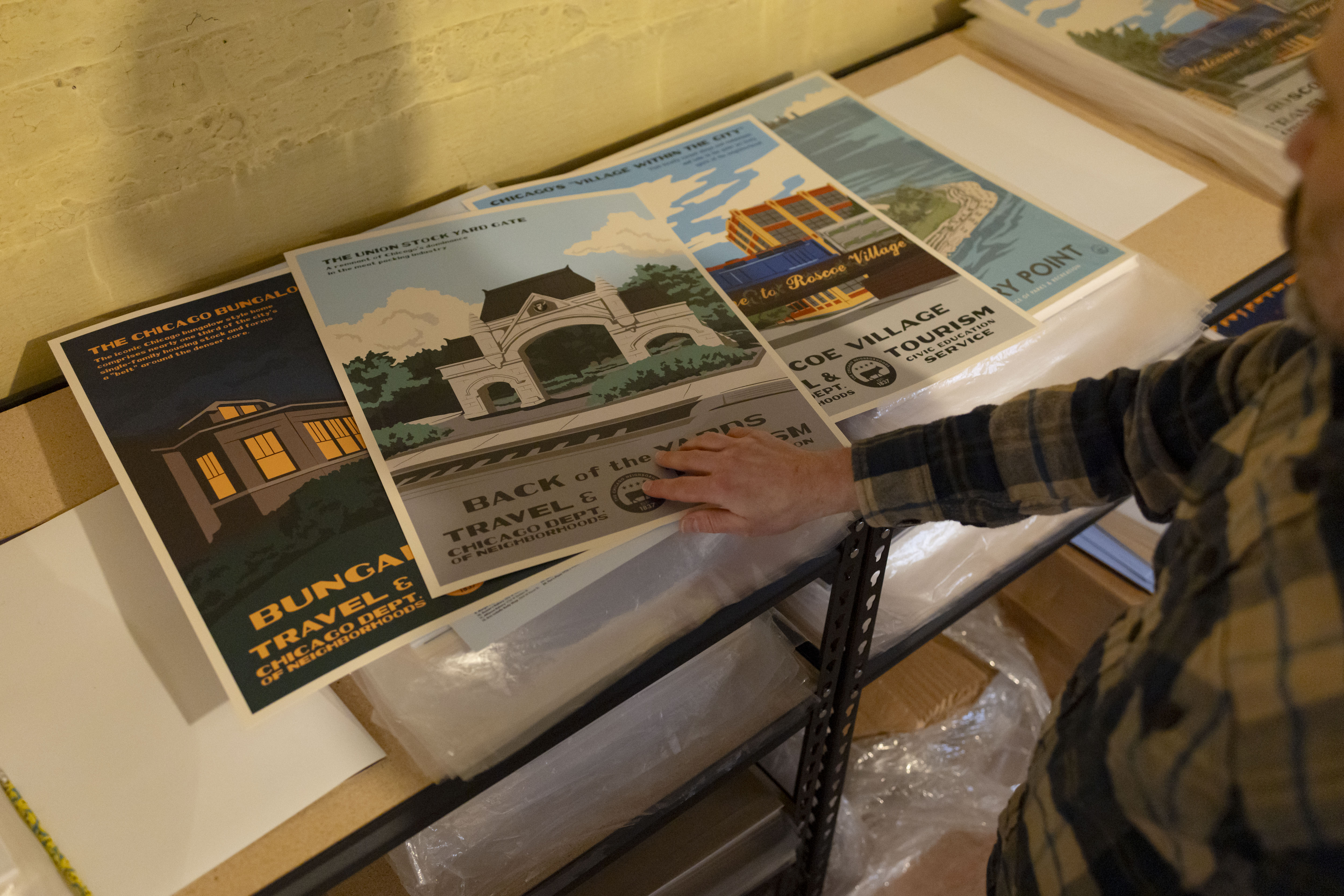 Artist Steve Shanabruch sorts some of his neighborhood prints at...