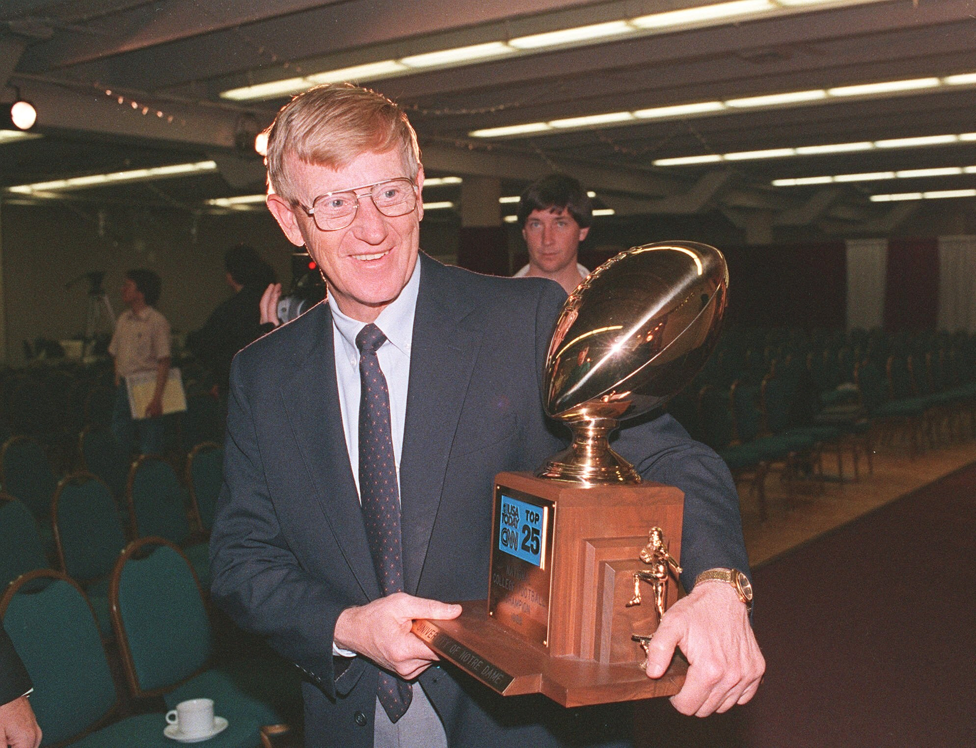 Notre Dame coach Lou Holtz carries away the national championship...