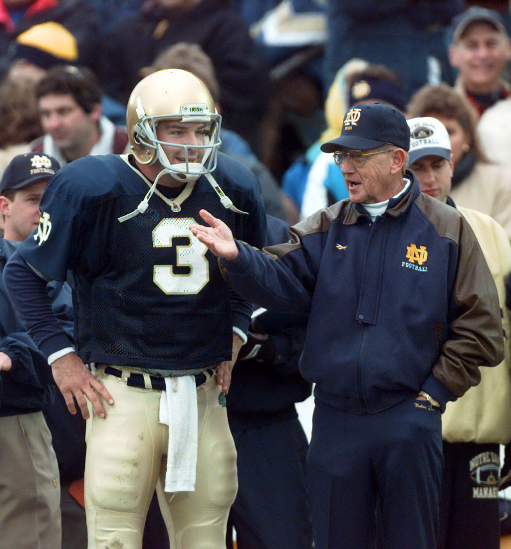 Notre Dame coach Lou Holtz shares a light moment with...