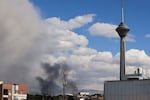 A plume of smoke rises following reported explosions in Tehran on March 1, 2026.