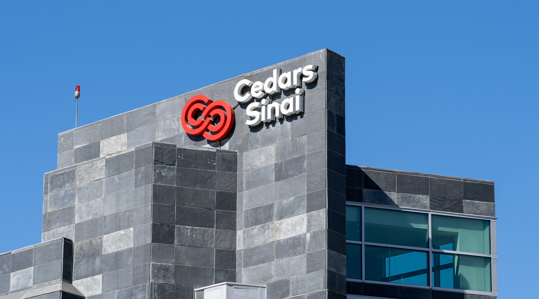 Los Angeles, CA, USA - July 7, 2022: Close up of Cedars Sinai logo on the building in Los Angeles, California, USA. Cedars-Sinai Medical Center is a nonprofit hospital and health science center.