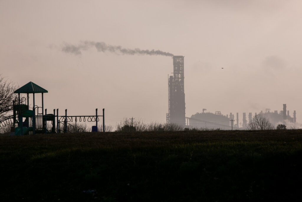 An ArcelorMittal iron ore plant smokes behind a playground at Simpson Park in Portland, Texas, on March 4, 2026. Dylan Baddour/Inside Climate News