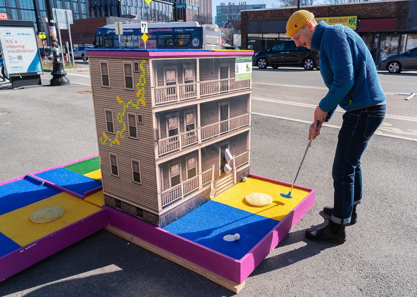 CultureHouse Executive Director Aaron Greiner took a swing at a new mini golf hole his nonprofit recently placed in Somerville's Union Square.