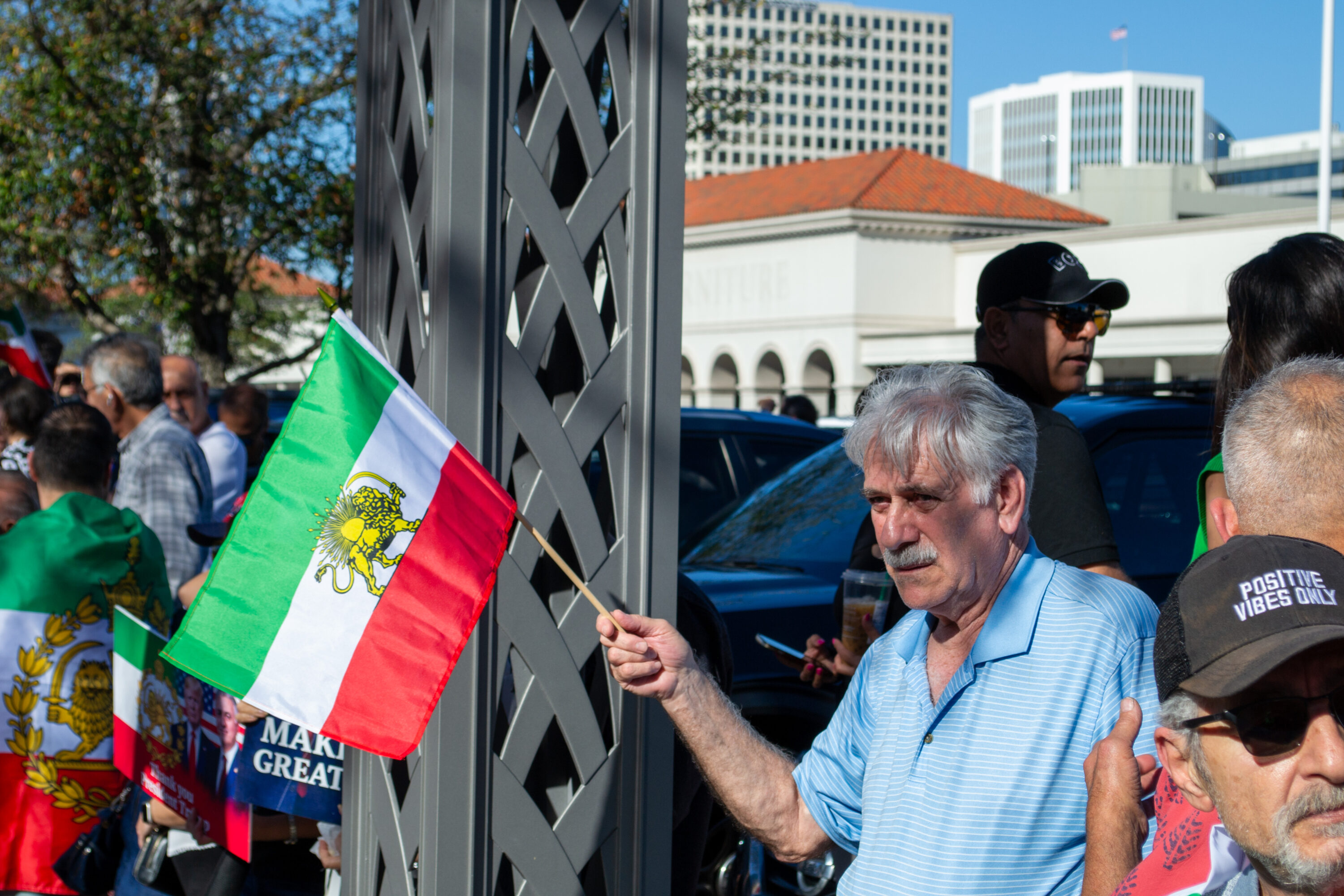 A man holds an Iranian Lion and Sun flag at a Demonstration in Houston one day after Ayatollah Ali Khamenei was killed. March 1, 2026.