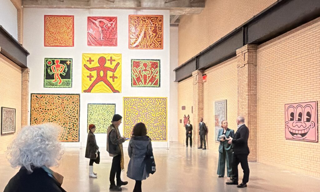 Large tarp works and iconic paintigs are shown in the Keith Haring show's primary room