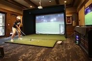 Zack Sheehan plays on a golf simulator  at the Craig Ranch Country Club in McKinney, Texas,...