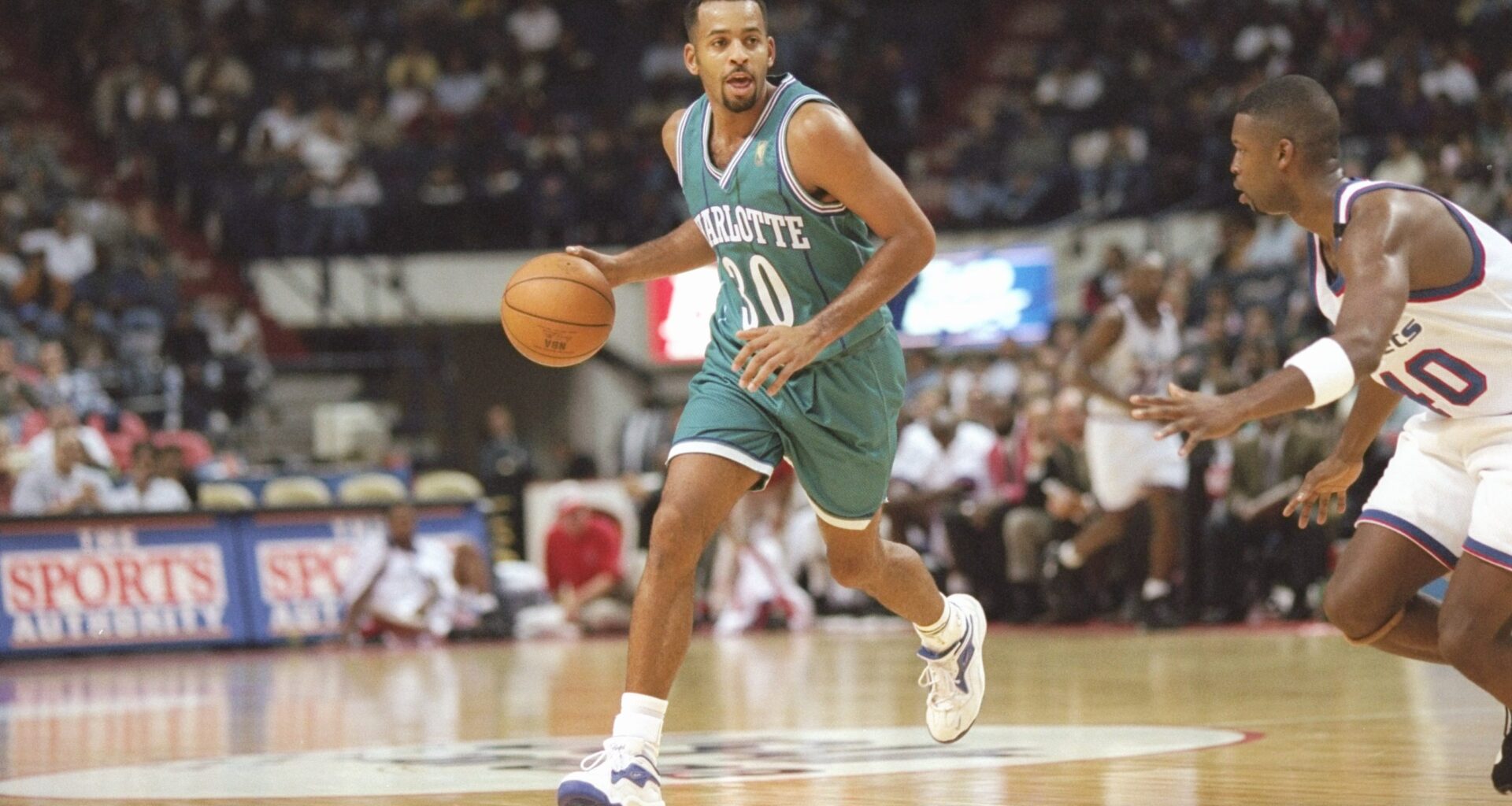 Dell Curry dribbles the ball