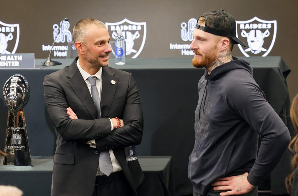 Raiders GM John Spytek talks with star pass rusher Maxx Crosby in early 2025.