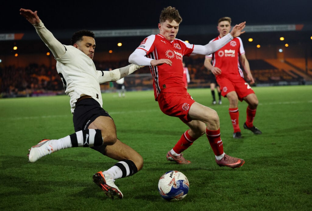 Ethan Ennis challenges for the ball in Fleetwood Town kit.
