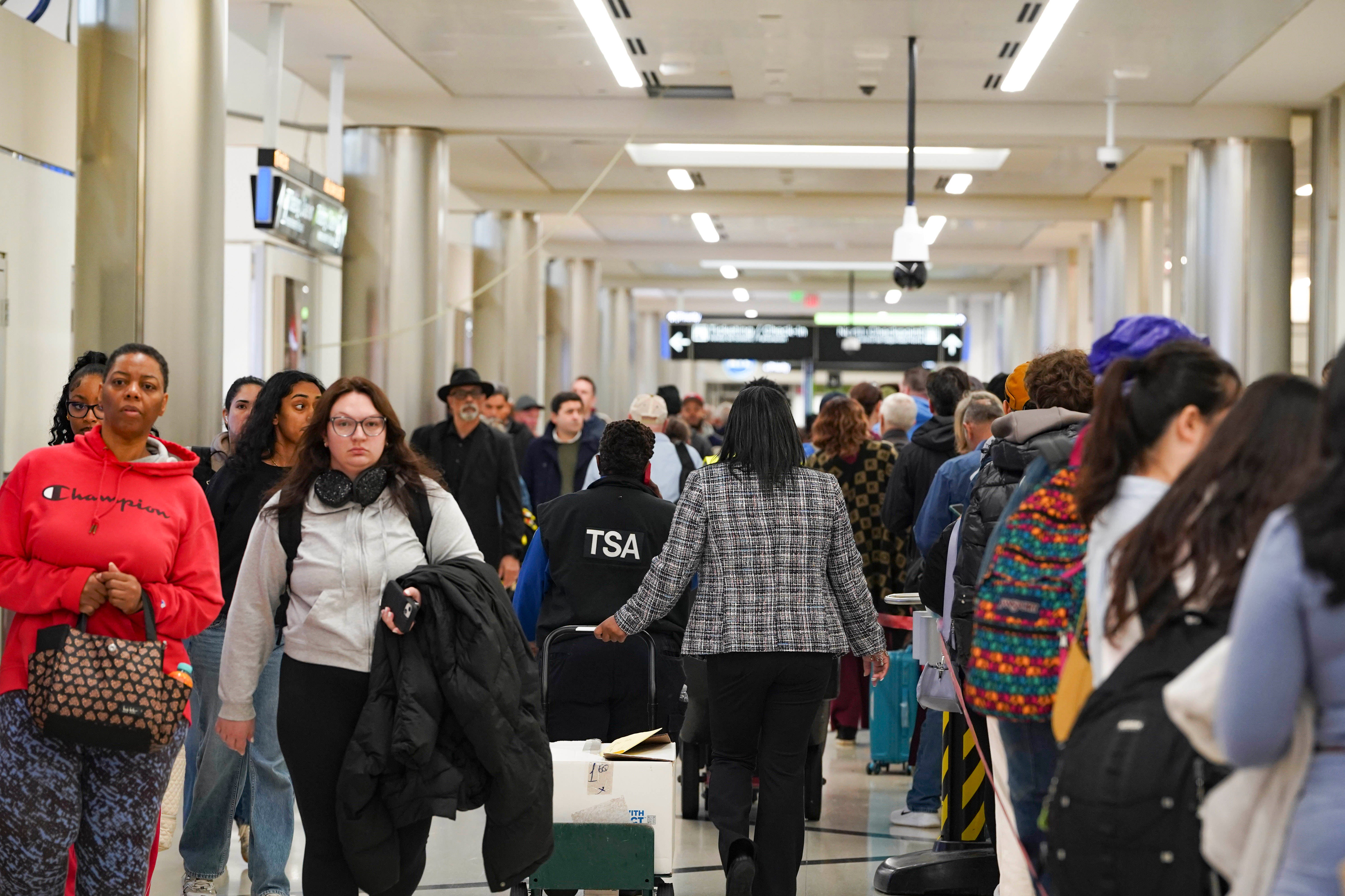 Travelers wait in long lines at Hartsfield-Jackson Atlanta International Airport on Monda in Atlanta, Georgia. Georgia and other U.S. states are seeing an increase in cases of HMPV