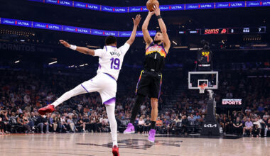 PHOENIX, ARIZONA - MARCH 28: Devin Booker #1 of the Phoenix Suns shoots the ball against Ace Bailey...