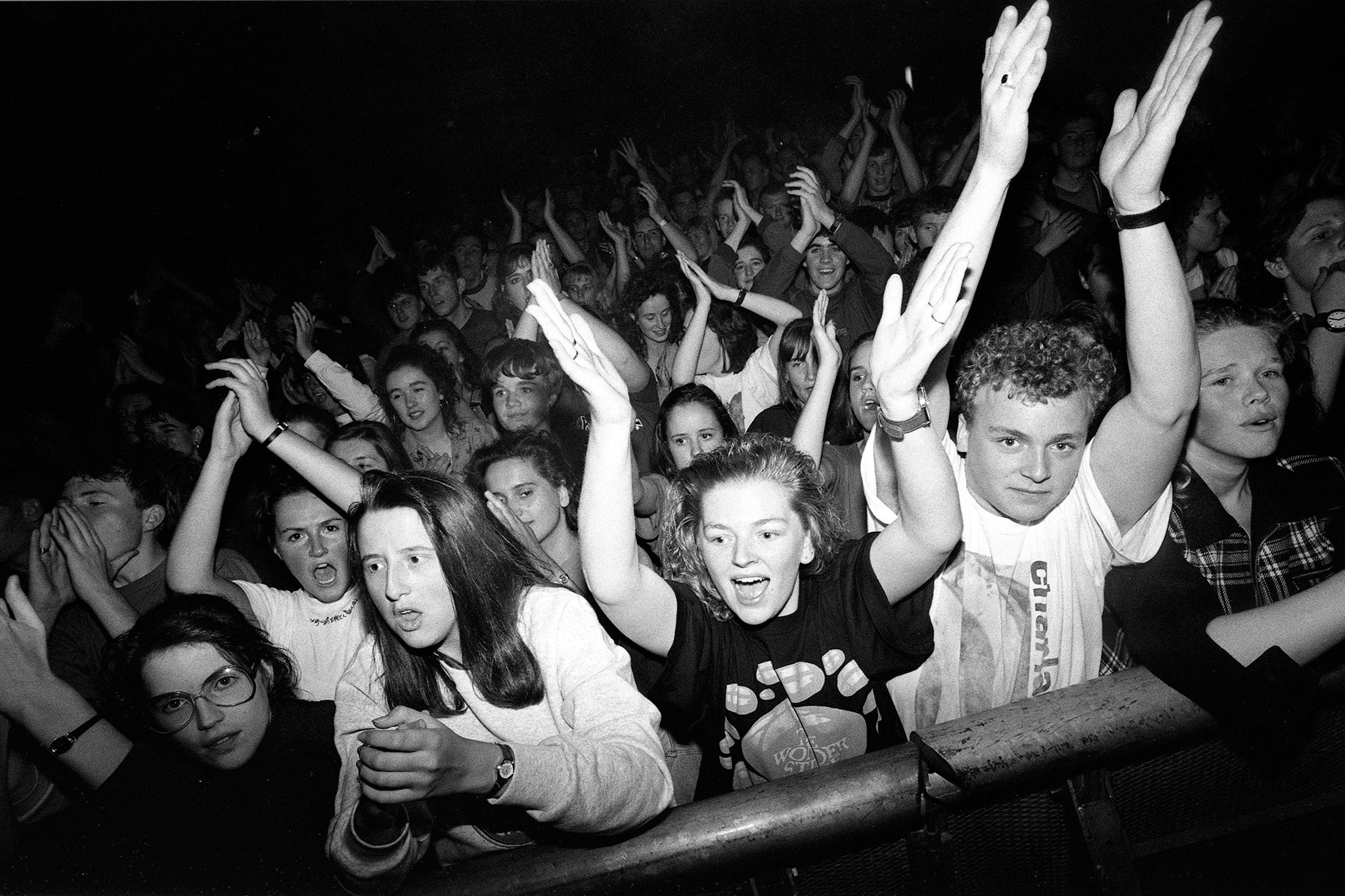 Early 1990s indie music fans in the front rows of the crowd at a gig, London, 1990