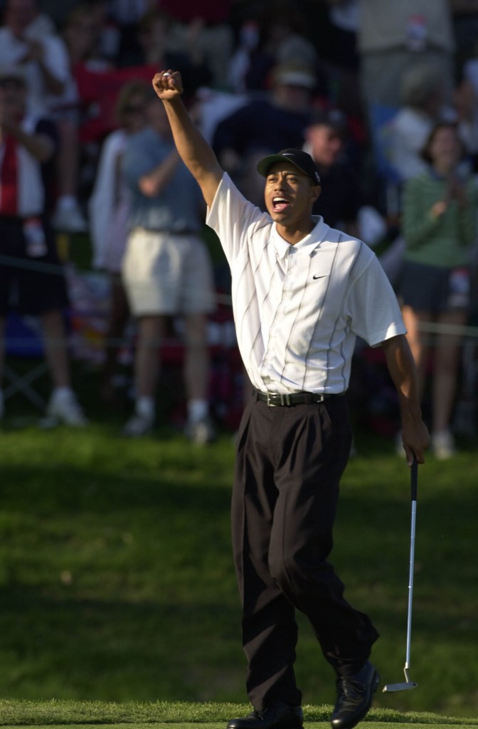 Tiger Woods celebrates after holing a long birdie on the 17th hole at  TPC at Sawgrass during the third round of play at The Players Championship in Ponte Vedra Beach, Florida.  