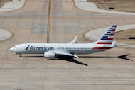 An American Airlines plane taxis to a gate at DFW International Airport, Wednesday, Feb. 11,...