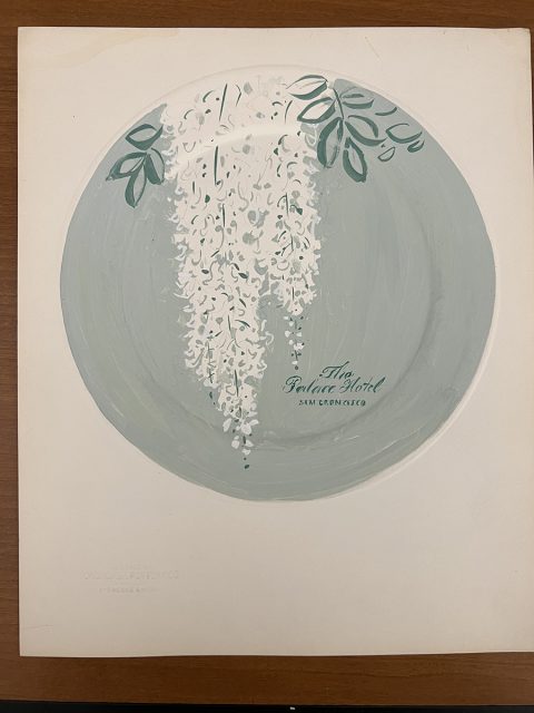 An illustrated plate with cascading white flowers and green leaves, labeled "The Palace Hotel San Francisco," is displayed on a wooden surface.