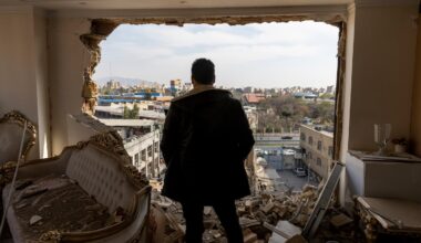 A man stands in a damaged residence on March 14, 2026 at the site of buildings, including a police station, that were destroyed in an airstrike two days ago in the Khani Abad neighbourhood of Tehran, Iran. According to authorities, the police station was empty at the time of the attack but six civilians were killed. The United States and Israel have continued a campaign of air strikes in Iran after launching their joint war on the country on February 28.
