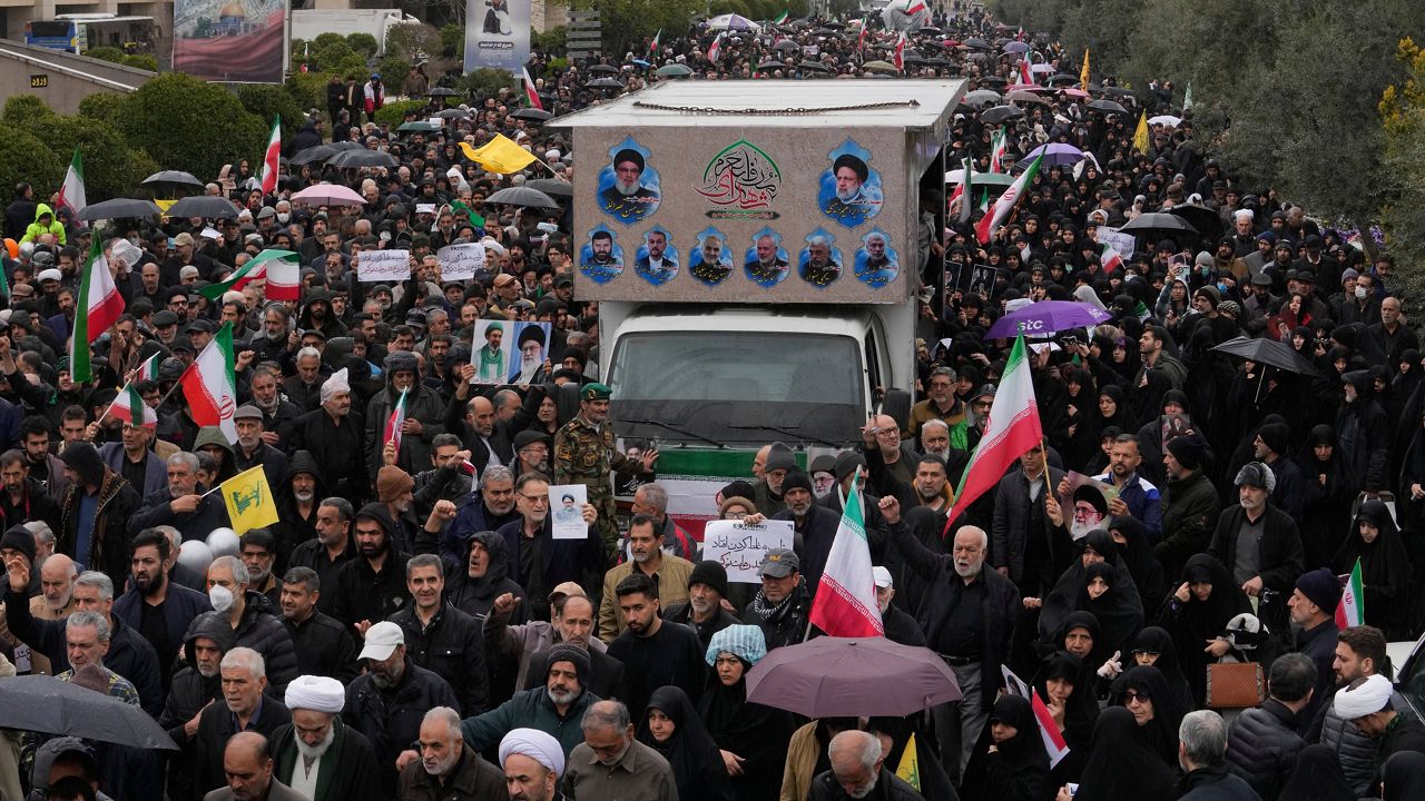 Iranians follow a truck carrying the coffins of Iran's intelligence minister Esmail Khatib and, according to Iranian officials, his wife and daughter, during a funeral procession in Tehran, Iran, Friday, March 20, 2026. (AP Photo/Vahid Salemi)