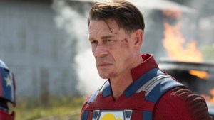 John Cena, with cuts on his face, suited up as Peacemaker (no helmet) in "Peacemaker"