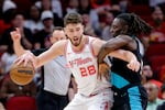 Houston Rockets center Alperen Sengun (28) drives into Portland Trail Blazers guard Jrue Holiday, right, during the first half of an NBA basketball game Friday March 6, 2026, in Houston.