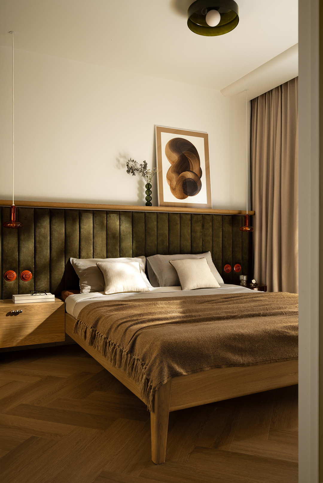 bedroom with wood bed, wood floors, and green wall accent