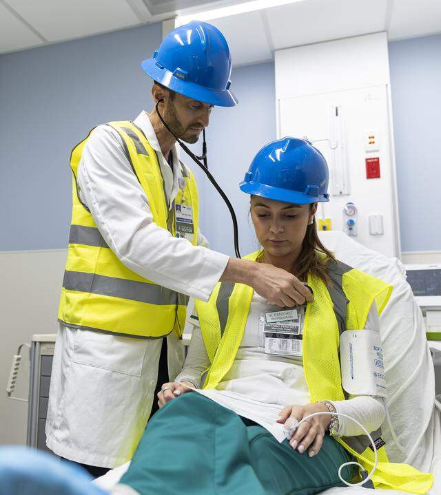 Jackson Memorial Hospital Dr. Mark Supino and Miami Dade College student Brittany Penichet perform a simulation of a patient's experience during a tour of the hospital's new emergency department on Thursday, March 5, 2026, in Miami, Fla. The new facility doubles the size of the current emergency room and is expected to reduce patient wait times.